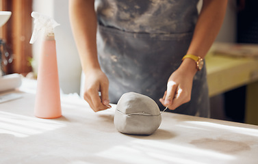 Image showing Woman, hands and cut clay in pottery studio, workshop and creative startup for sculpture product. Ceramic artist, wire cutter and process for production, manufacturing and designer in small business