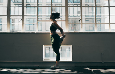 Image showing Exercise, stretching and a woman at gym for fitness workout for health and body wellness with muscle warm up. Sports female or athlete stretch legs at window for balance, energy and healthy lifestyle