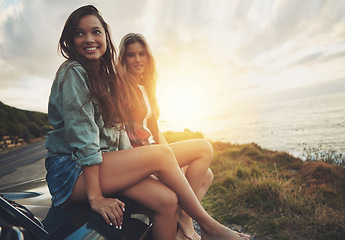 Image showing Friends at sunset, women on car with travel to beach, road trip portrait and outdoor with nature and sea holiday. Adventure mockup, freedom and gen z youth on summer vacation, happy with lens flare