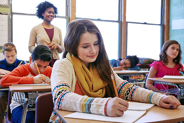 Image showing Education, writing and exam with children in classroom of college for academy, knowledge and learning. Study, school and notebook with students and teacher for future, scholarship and goal