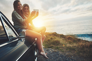 Image showing Friends at sunset, women and selfie on beach, travel and adventure on car outdoor, nature and sea holiday. Road trip mockup, happy in picture on summer vacation, smartphone photography and lens flare