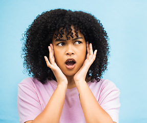 Image showing Shock, surprise face and black woman with isolated blue background in a studio. Wow, thinking and hands of a young person hearing a secret or surprising announcement feeling confused and annoyed