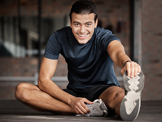 Image showing Portrait, fitness and stretching with a man athlete in gym getting ready for his workout routine. Exercise, health and warm up with a handsome young male training in a performance center for wellness
