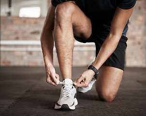 Image showing Fitness, man and tying shoe lace getting ready for running exercise, workout or training at gym. Sporty male, person or guy shoes in preparation for sport run, cardio or warm up on floor at gymnasium