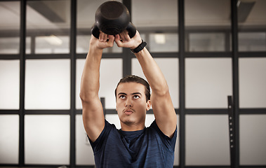 Image showing Man, kettlebell and gym fitness of a person training with focus mindset in a health studio. Power train, weight workout and wellness target goal of an athlete doing cardio and arm challenge breathing