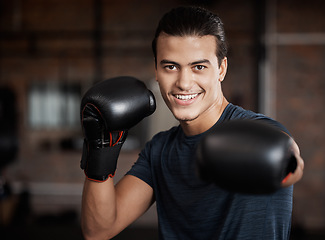 Image showing Portrait, fitness and workout with a boxer man training for a fight or competition in a gym for sports. Health, exercise and power with a young male athlete boxing in an mma or self defense club