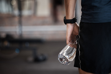 Image showing Water bottle, fitness and gym sports of a man at a wellness, training and exercise club with mockup. Sports, workout and athlete with mock up space ready for muscle and body development alone