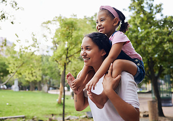 Image showing Back, mother carry girl and in park for fun, happiness and bonding on weekend break, loving and quality time. Mama, mom and female child on shoulders, nature and playful together, summer and outdoor