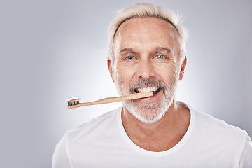 Image showing Grooming, dental hygiene and man brushing teeth for mouth health, happy smile and clean teeth on a studio background. Healthcare, oral care and face portrait of a senior model with a toothbrush