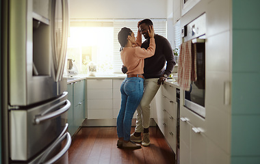 Image showing Black couple, love and bonding in the kitchen at home with care and happiness in a marriage with commitment. Young man and woman together with a romantic hug while in their house or apartment