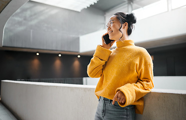 Image showing Phone call, communication and mockup with an asian woman talking while standing in a hallway. Mobile, networking and conversation with an attractive young female speaking on her smartphone indoor