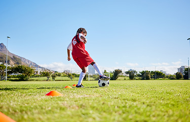 Image showing Soccer girl child, field and training for fitness, sports and balance for control, speed and strong body from low angle. Female kid, fast football dribbling and exercise feet on grass in Cape Town