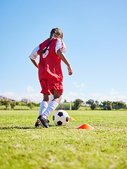 Image showing Sports, training and girl playing soccer for fitness, physical activity and hobby on a field in Spain. Active, focus and athlete dribbling a football for a game, cardio and match on the grass