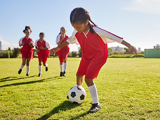 Image showing Soccer, training or sports and a girl team playing with a ball together on a field for practice. Fitness, football and grass with kids running or dribblinf on a pitch for competition or exercise