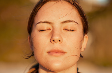 Image showing Face, relax and peace with a woman outdoor in nature, standing alone for zen, calm or serenity. Mindset, wellness and mental health with an attractive young female breathing outside for mindfulness