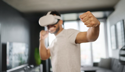 Image showing VR, metaverse and man boxing on a game, training for a fight and match. Futuristic, digital sports and gamer punching while playing in an augmented reality with technology glasses in a house