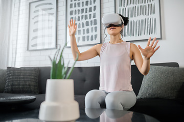 Image showing VR, metaverse and technology with a woman in the living room of her home using a headset to access a 3d game. Futuristic, virtual reality and gaming with a female gamer using ai to access games