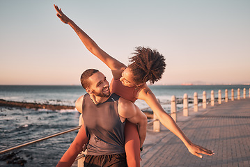 Image showing Beach, happy and couple piggyback in summer enjoying holiday, vacation and quality time on weekend. Love, dating and black man and woman relax after running, fitness workout and training by ocean