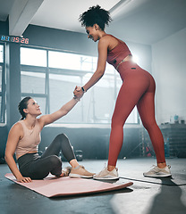 Image showing Fitness, personal trainer or black woman helping a girl client at gym with trust or support after workout or exercise. Partnership, helping hand or healthy sports athlete training with a female coach