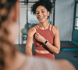 Image showing Fitness, personal trainer and black woman shaking hands at gym for team work, trust or support in a workout or exercise. Collaboration, friends or healthy sports athletes handshake in training club