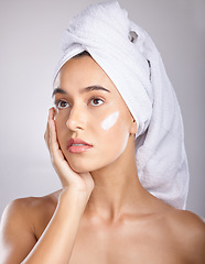 Image showing Woman, head towel and cream for cosmetics, makeup and face detox on grey studio background. Young female, lady and organic facial for treatment, clear and healthy skin for natural beauty and skincare