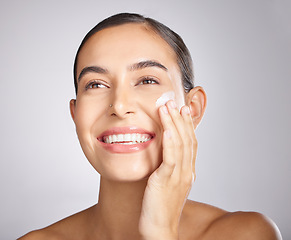 Image showing Beauty, skincare and product with cream and woman for facial, sunscreen and moisturizing. Happy, smile and dermatology with lotion on face of girl model for health, self care and glow in studio