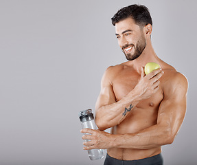 Image showing Man, water bottle and apple for healthy lifestyle, diet and wellness in grey studio background. Male, guy and bodybuilder with fruit, hydration and healthcare for fitness, nutrition and motivation