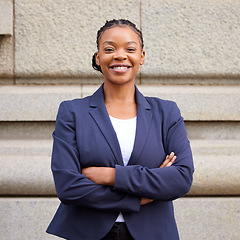 Image showing Mission, vision and mindset with a business black woman standing arms crossed outdoor in the city alone. Success, motivation and growth with a female employee looking confident in an urban town