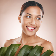 Image showing Woman, face skincare and monstera leaf on pink studio background for organic dermatology, self love or healthcare wellness. Happy, smile or beauty model with green plant, natural makeup or cosmetics