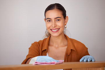 Image showing Portrait, cleaning and wipe with a woman housekeeper or cleaner using a rag cloth to dust furniture. Face, bacteria and dirt with a female working to service a dirty apartment for housekeeping