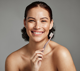 Image showing Dental portrait, toothbrush and a woman brushing teeth for hygiene, cleaning and teeth whitening for wellness. Face of happy female with a smile for oral health, healthy mouth and self care in studio