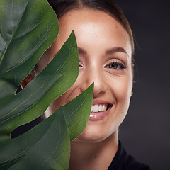 Image showing Beauty, skin and face with leaf and woman, skincare with nature aesthetic, natural cosmetics and facial portrait against studio background. Smile, glow with organic cosmetic treatment and wellness.