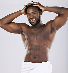 Image showing Black man in towel and skin in portrait, shower and hygiene, grooming and beauty isolated on studio background. Smile, muscle and abs, strong and skincare glow, body care with natural cosmetics