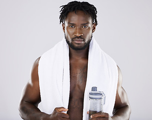 Image showing Fitness, portrait and black man with towel and water for sports in studio for strong body muscle. Health and wellness of a sexy male bodybuilder model after exercise, workout and training for power