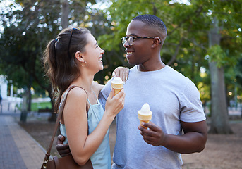 Image showing Love, ice cream or couple of friends hug in a park on a romantic date in nature in an interracial relationship. Bonding, relaxed black man and happy woman enjoying a snack on a fun holiday vacation