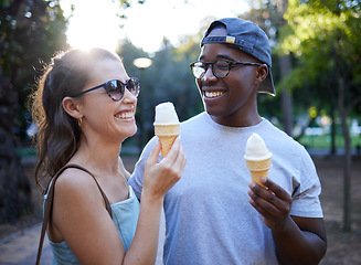 Image showing Interracial couple, laughing and ice cream in a park for funny joke, conversation or bonding together. Happy man and woman sharing laugh with smile for humor, trip or holiday with desert in nature