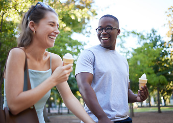 Image showing Interracial couple, laughing and ice cream for funny joke, conversation or bonding together in the park. Happy man and woman sharing laugh with smile for humor, trip or holiday with desert in nature