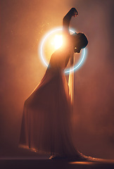 Image showing Orange lighting, art deco and silhouette of woman with neon circle for creative, fantasy and beauty. Dance, aesthetic and shadow of angel or goddess for dream, magic and freedom in glowing studio