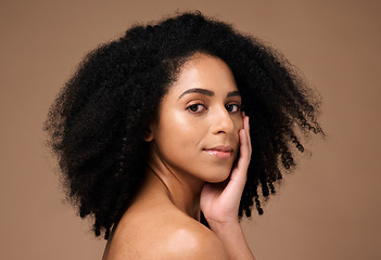 Image showing Portrait, beauty and afro with a model black woman in studio on a brown background for natural skincare. Face, cosmetics and hair with an attractive young female posing to promote cosmetics