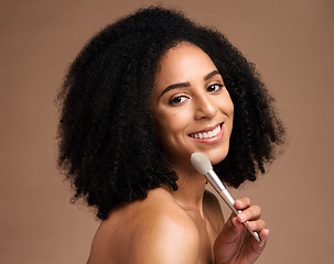 Image showing Face portrait, beauty and black woman with makeup brush in studio isolated on a brown background. Skincare, cosmetics tool and happy female model with product to apply foundation for facial wellness.