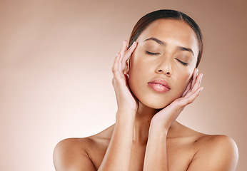 Image showing Skincare, beauty and relax, woman with eyes closed and facial massage on studio background. Makeup, glamour and luxury skin care with hands massaging face, mockup for acupressure detox on black woman