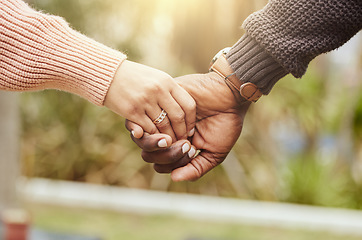 Image showing Love, support and trust hands of black couple in marriage together with care, romance and unity. Soulmate, married and man with woman holding hands for romantic bonding moment in nature zoom.