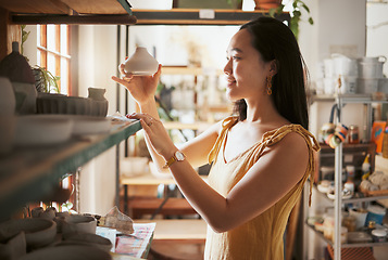 Image showing Pottery, small business and display with a woman entrepreneur working in a studio, selling products for retail. Startup, manager or sale with a female owner at work in a workshop for artistic design