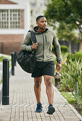 Image showing Fitness, travel or black man walking to gym for body training, exercise or workout with water bottle or gym bag in Atlanta. Path, mindset or healthy sports athlete with wellness goals or motivation