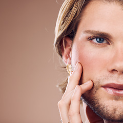 Image showing Face, eye and beauty with mockup and man for skincare, cosmetics with microblading, vision and glow against studio background. Cosmetic care, makeup and facial cropped with gender neutral closeup