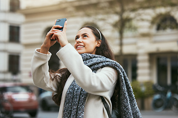 Image showing Travel, tourist and photograph with a woman in the city taking a picture while traveling abroad on holiday or vacation. Phone, tourism and mobile with a female traveler while sightseeing overseas