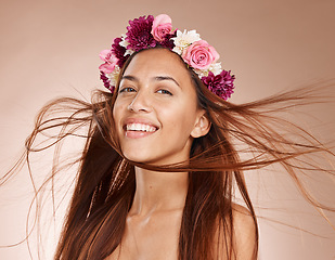 Image showing Woman, portrait and flowers on crown, studio background and windy hair for healthy skincare in Brazil. Happy face, floral headband and model of beauty, spring fashion and natural makeup of eco plants