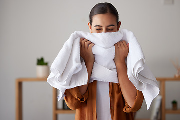 Image showing Laundry, fresh and woman smelling a towel after cleaning, housework and washing clothes in the morning. Chores, housekeeping and cleaner with smell of clean clothing after a routine wash at home