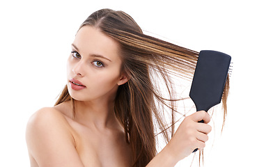 Image showing Beautiful, young and woman brushing hair for self love and self care or hygiene against a white studio background. Portrait of isolated attractive female using brush for haircare or hair treatment