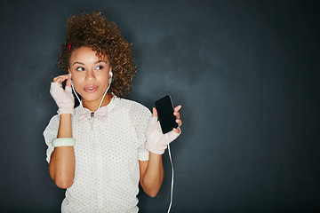 Image showing Music, podcast and black woman with a phone for the radio isolated on a black background. Audio, thinking and African girl with a mobile streaming songs with mockup space on a studio backdrop